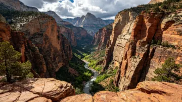 In the deep valley a river rushes along with steep cliffs st
